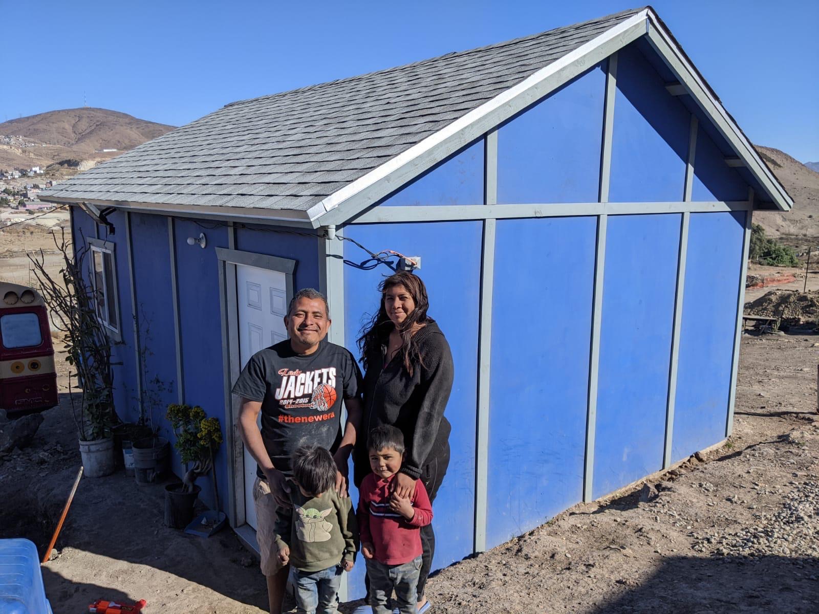 Family standing in front of their new Casa De David home