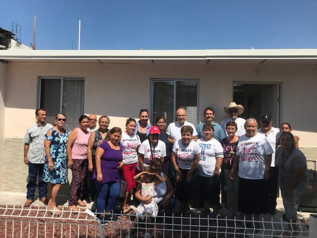 Community gathered in front of a new home
